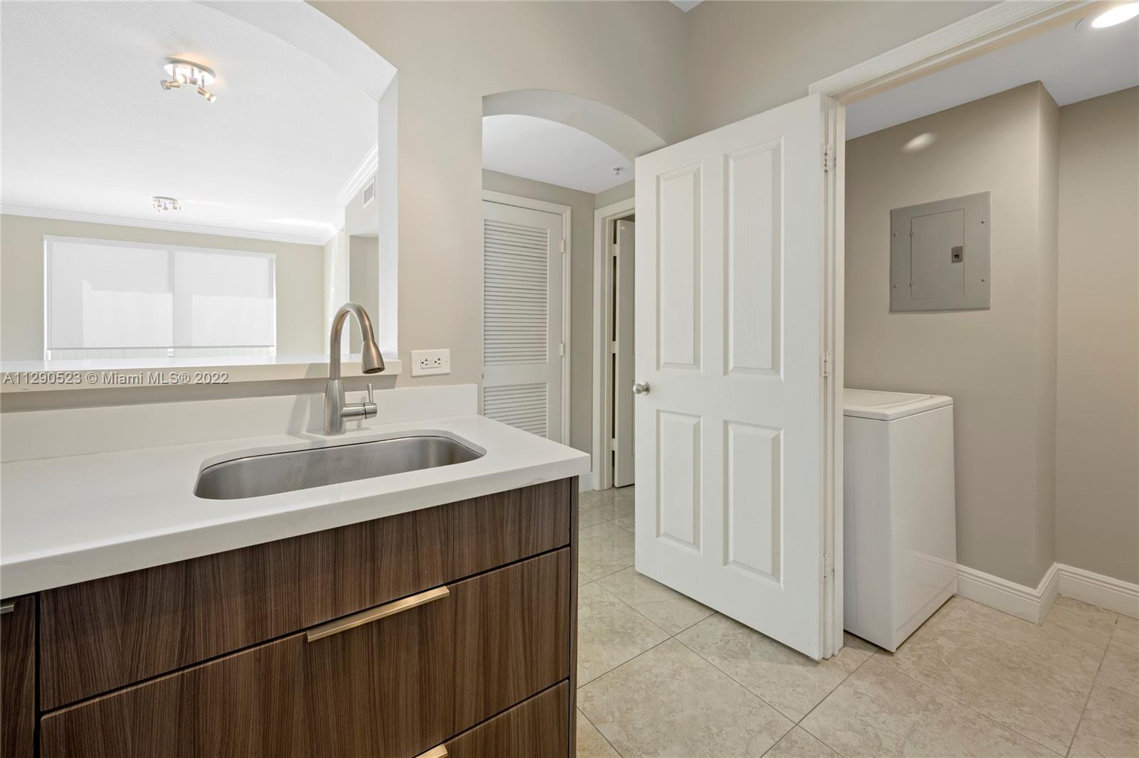 9172 Collins Avenue, Unit 403 Surfside, FL 33154 - Photo 13 of 30 a bathroom with a sink and a mirror