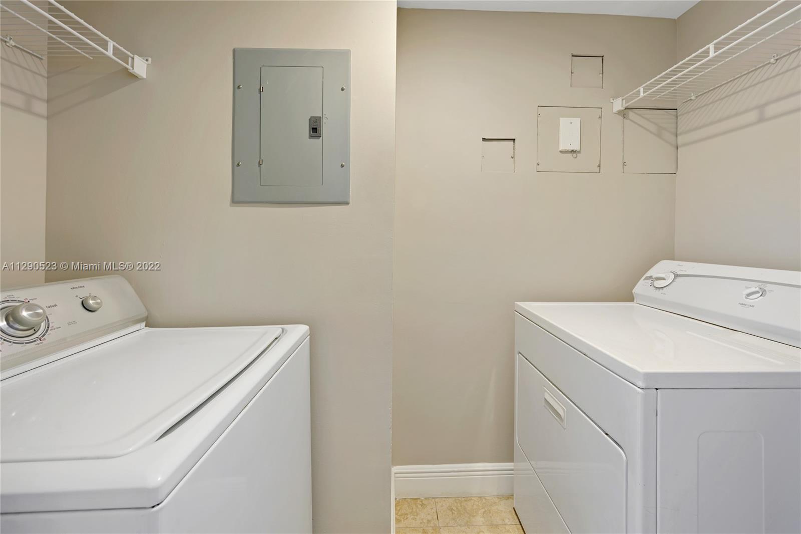 9172 Collins Avenue, Unit 403 Surfside, FL 33154 - Photo 14 of 30 a utility room with dryer and washer