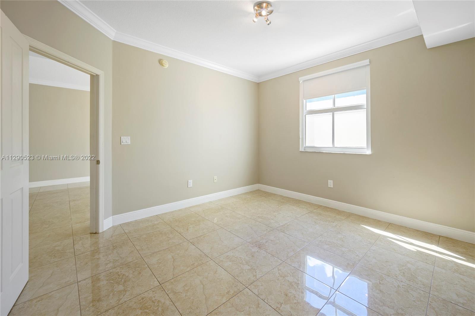 9172 Collins Avenue, Unit 403 Surfside, FL 33154 - Photo 16 of 30 a view of an empty room with a window