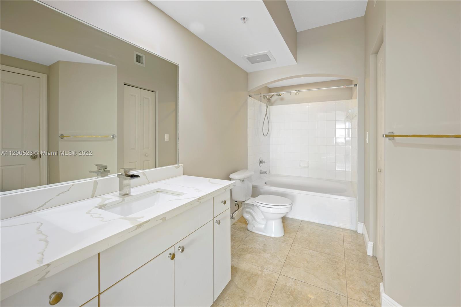9172 Collins Avenue, Unit 403 Surfside, FL 33154 - Photo 19 of 30 a bathroom with a sink a toilet and shower