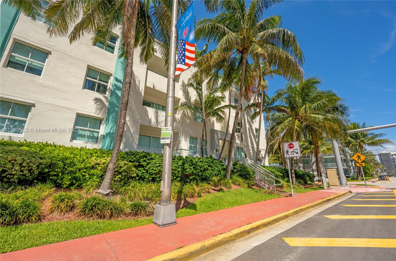 9172 Collins Avenue, Unit 403 Surfside, FL 33154 - Photo 2 of 30 a view of a yard with plants and palm trees