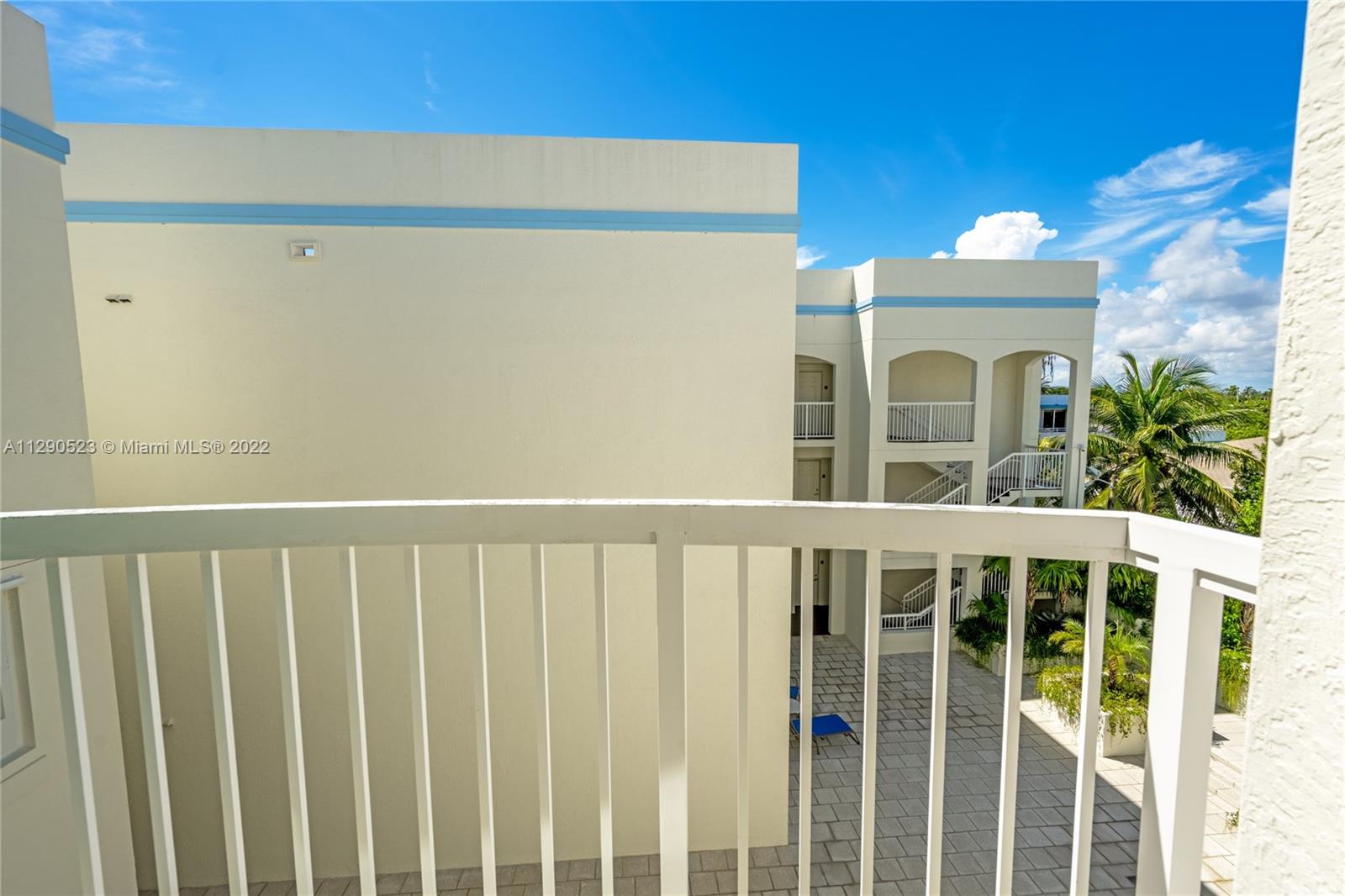 9172 Collins Avenue, Unit 403 Surfside, FL 33154 - Photo 21 of 30 a view of a brick house with a wooden fence