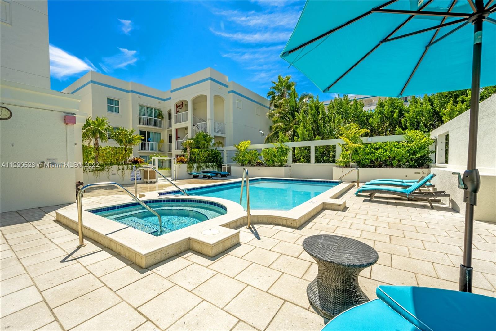 9172 Collins Avenue, Unit 403 Surfside, FL 33154 - Photo 27 of 30 a view of a house with swimming pool and sitting area