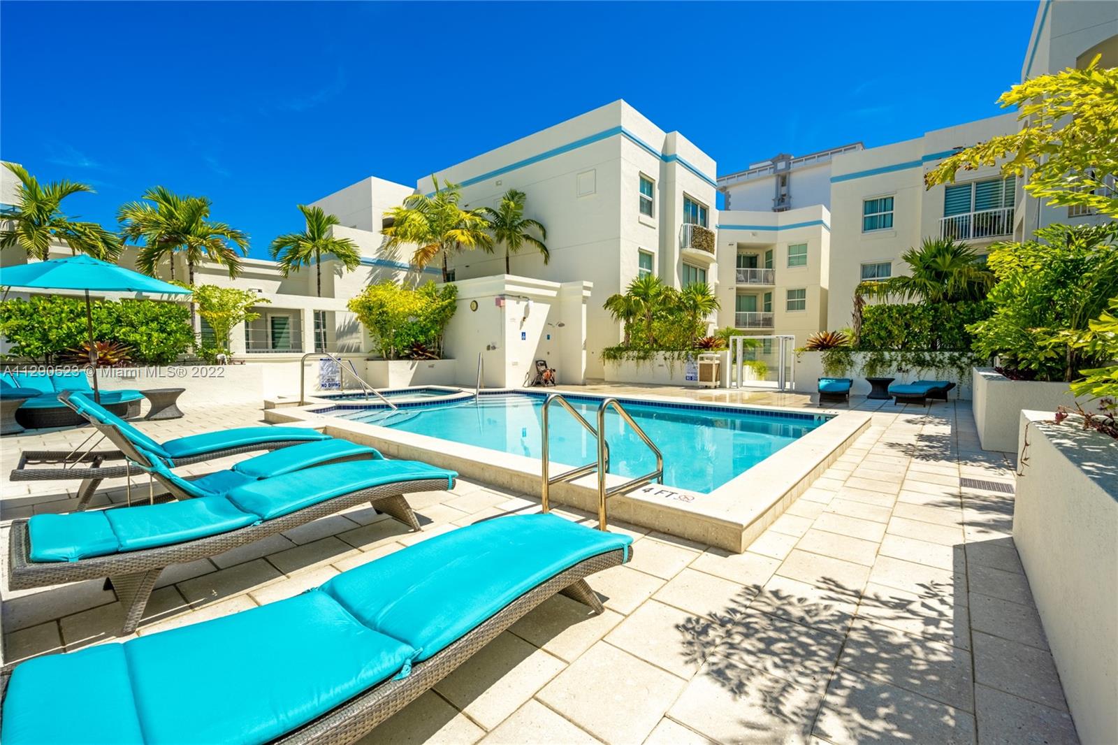 9172 Collins Avenue, Unit 403 Surfside, FL 33154 - Photo 29 of 30 a view of a house with swimming pool and sitting area