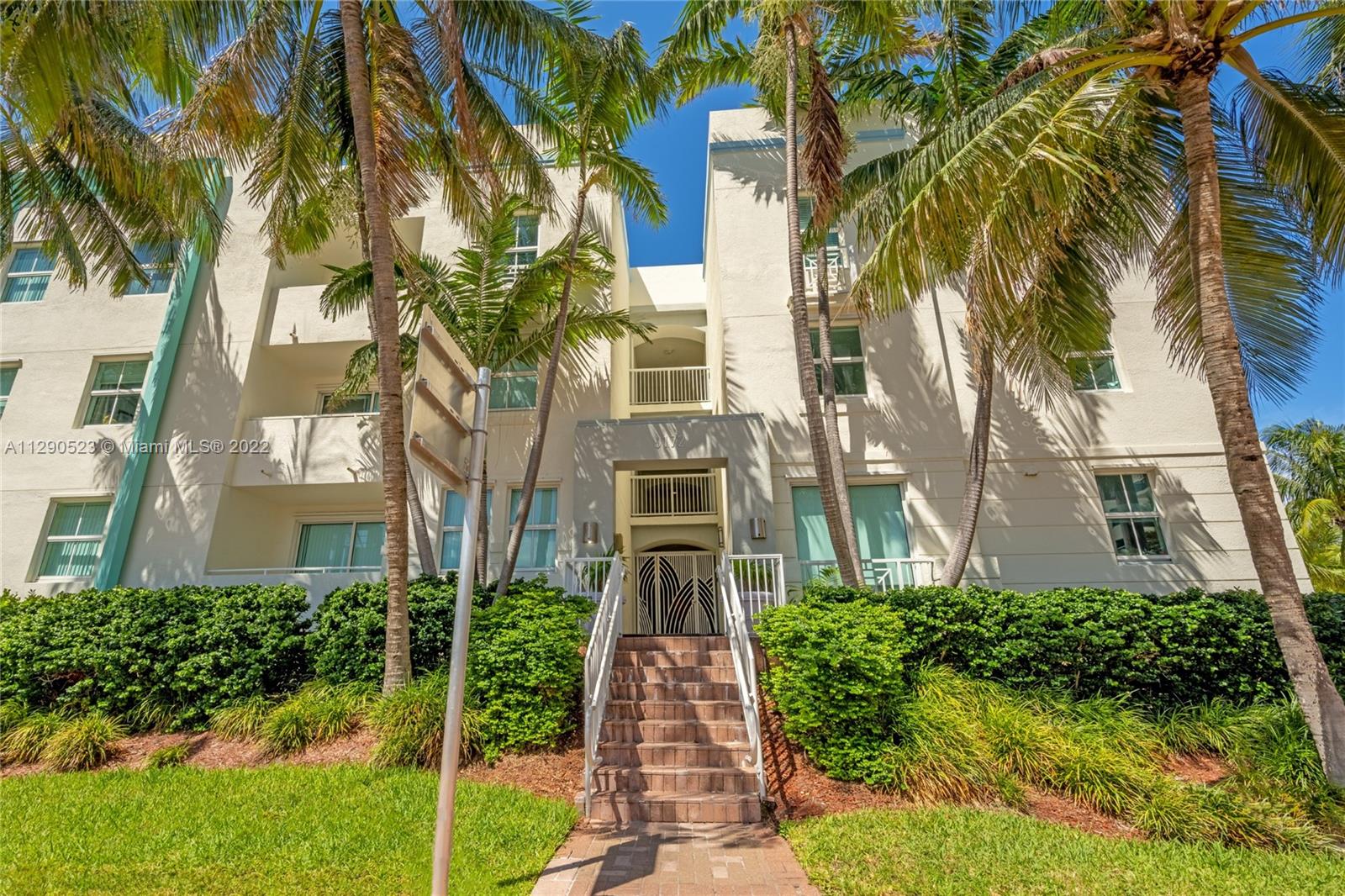 9172 Collins Avenue, Unit 403 Surfside, FL 33154 - Photo 4 of 30 front view of a multi story building with a yard