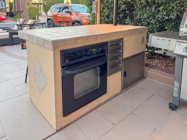 a stove top oven sitting inside of a kitchen