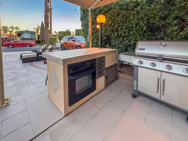 a view of a patio with table and chairs