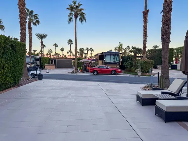 a view of a patio with a table and chairs under an umbrella