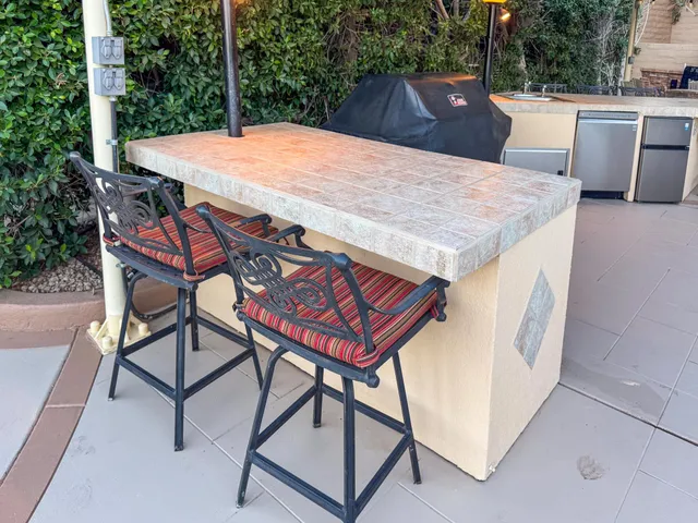 a view of a patio with table and chairs