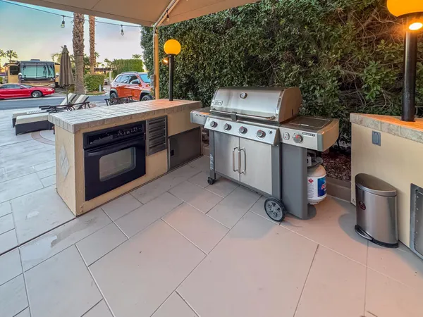 a open kitchen with a stove and a microwave oven with cabinets