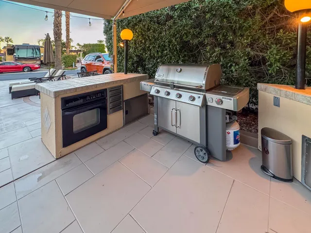a open kitchen with a stove and a microwave oven with cabinets