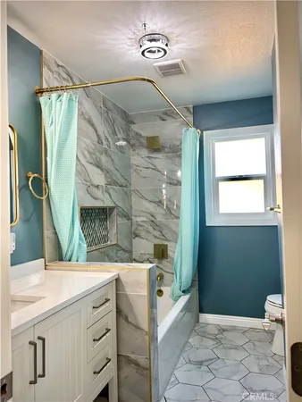 a bathroom with a sink mirror and a bathtub