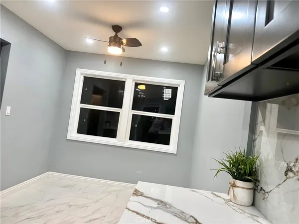 a bedroom with a bed and a potted plant