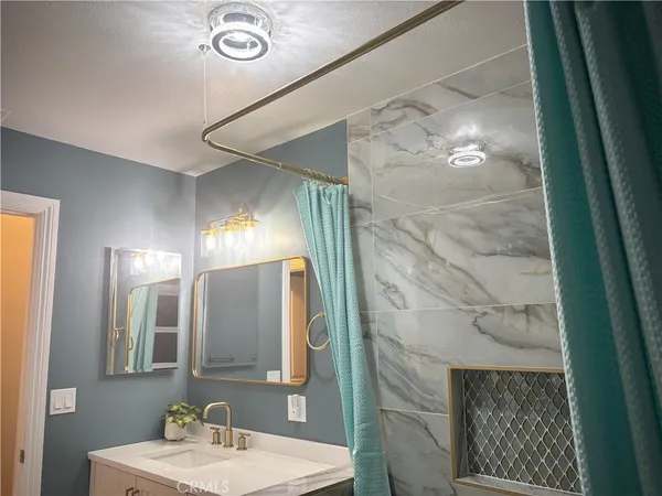 a bathroom with a mirror and a shower