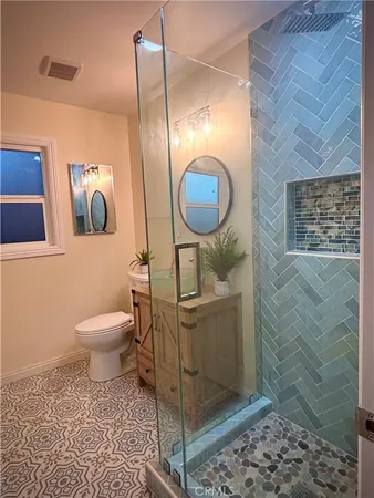 a bathroom with a toilet a sink and mirror