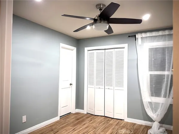 a view of a livingroom with a window and a ceiling fan