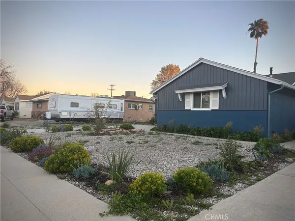 a view of a house with a small yard and plants