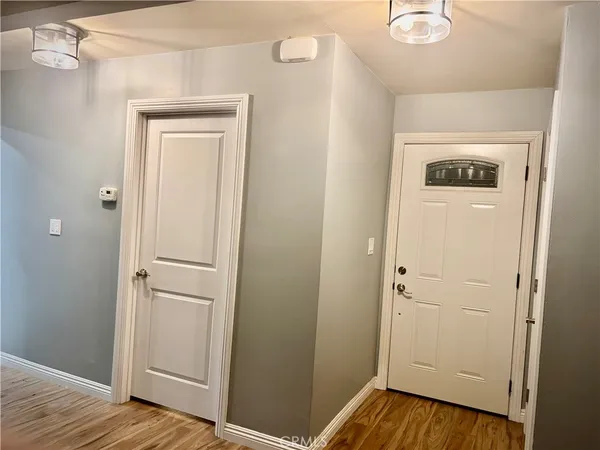 a view of a hallway with wooden floor
