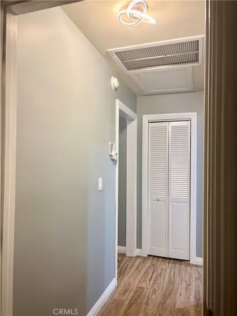 a view of hallway with wooden floor