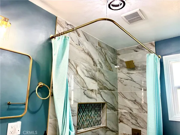 a bathroom with a shower and a mirror