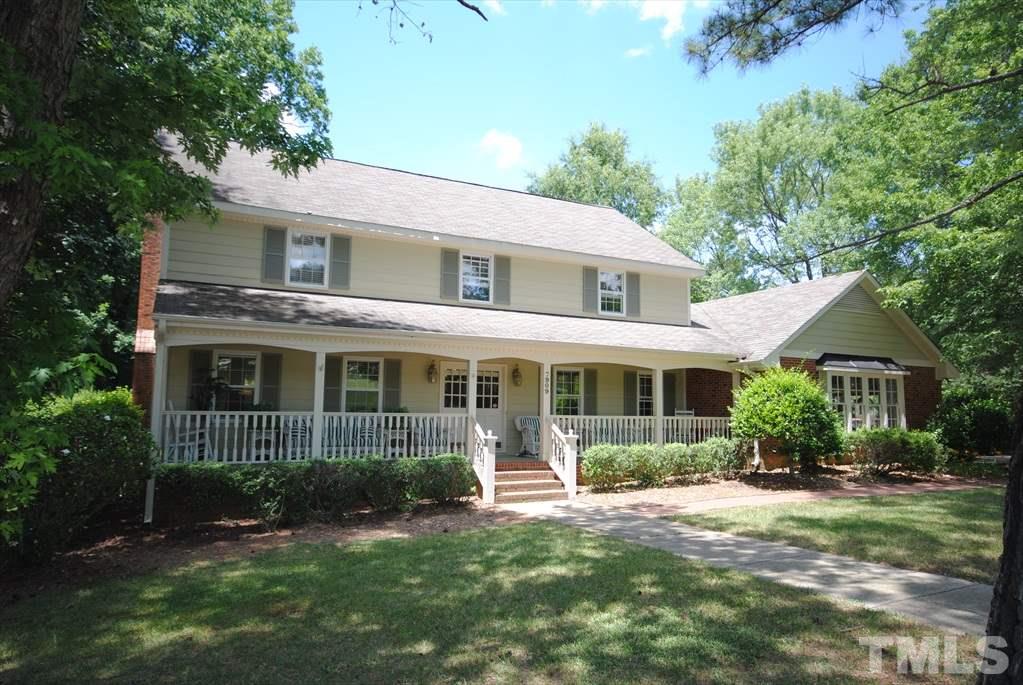 7909 Harps Mill Road Raleigh, NC 27615 - Photo 3 of 25 a front view of a house with a yard and potted plants