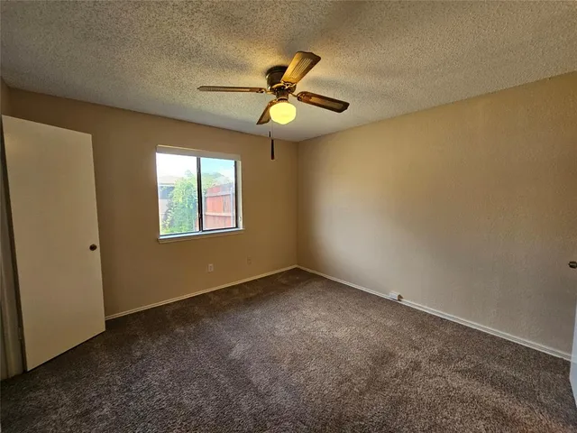 a view of a big room with closet and a chandelier fan