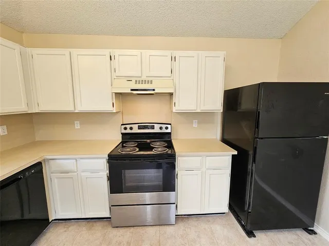 a kitchen with a stove and a refrigerator