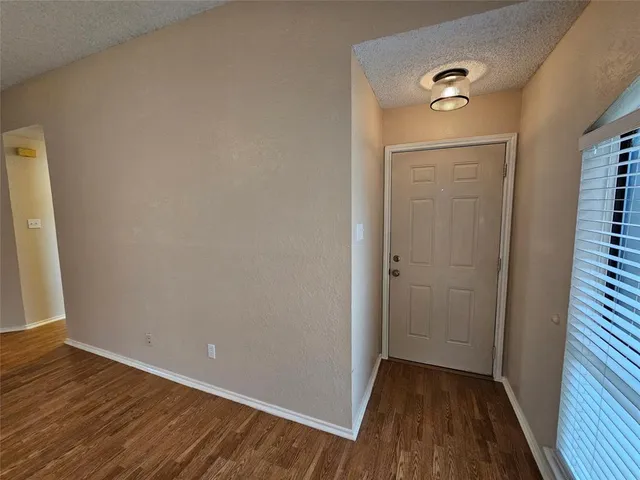 a view of a room with wooden floor