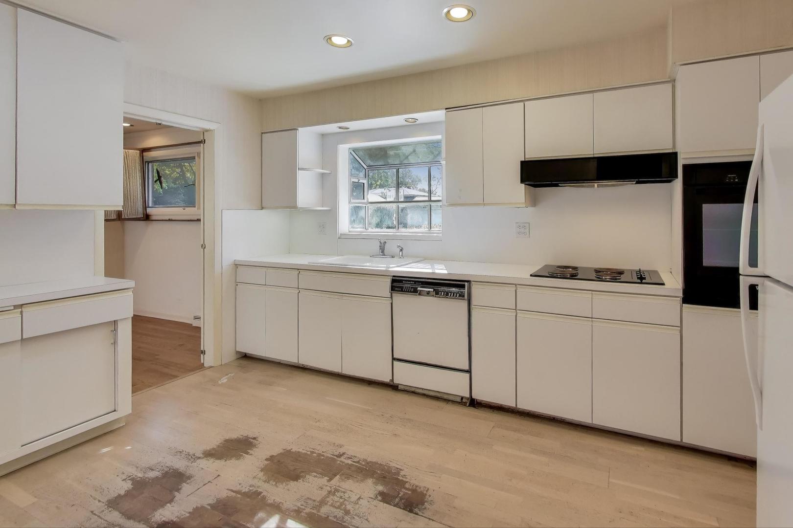 313 Ferndale Road Glenview, IL 60025 - Photo 6 of 22 a kitchen with white cabinets a sink and appliances