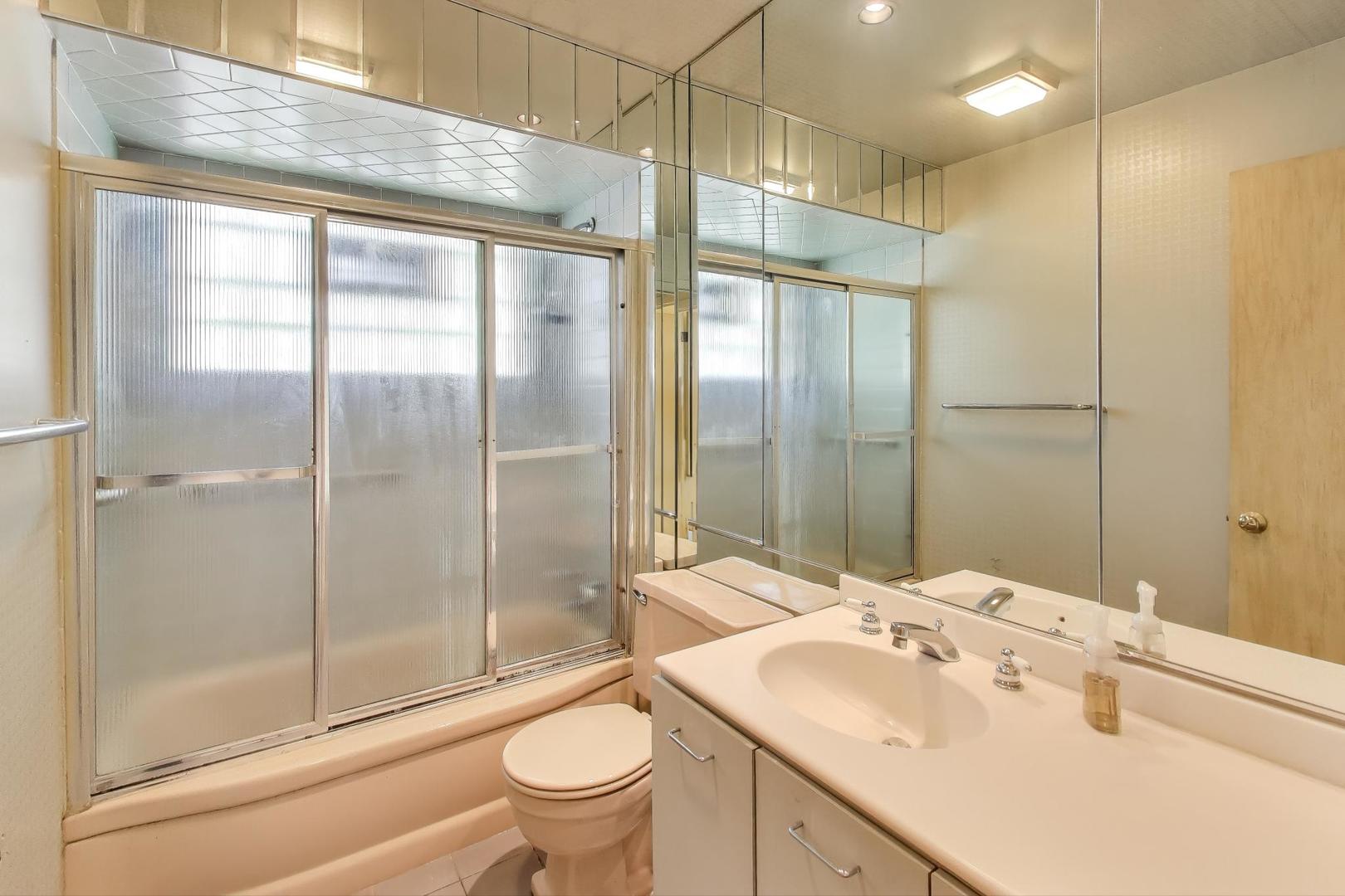 313 Ferndale Road Glenview, IL 60025 - Photo 10 of 22 a bathroom with a shower sink vanity mirror and toilet