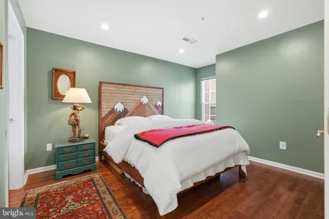 a bedroom with a bed and a lamp