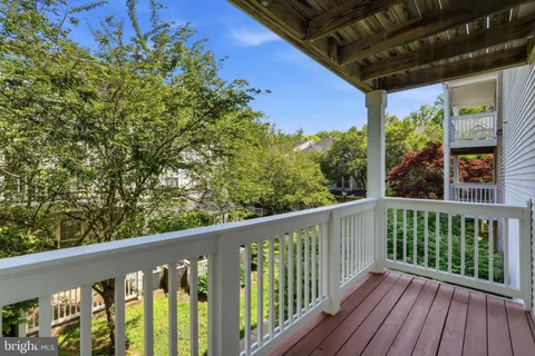 a view of a balcony with wooden floor