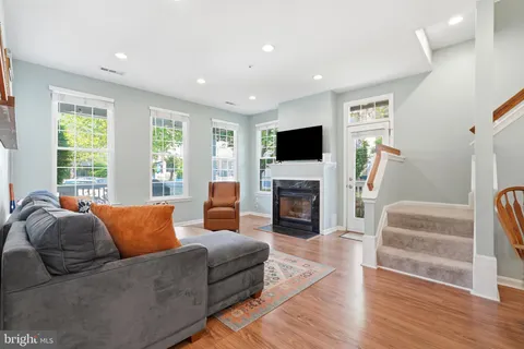 a living room with furniture flat screen tv and a fireplace