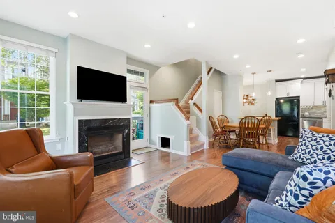 a living room with furniture fireplace and a flat screen tv