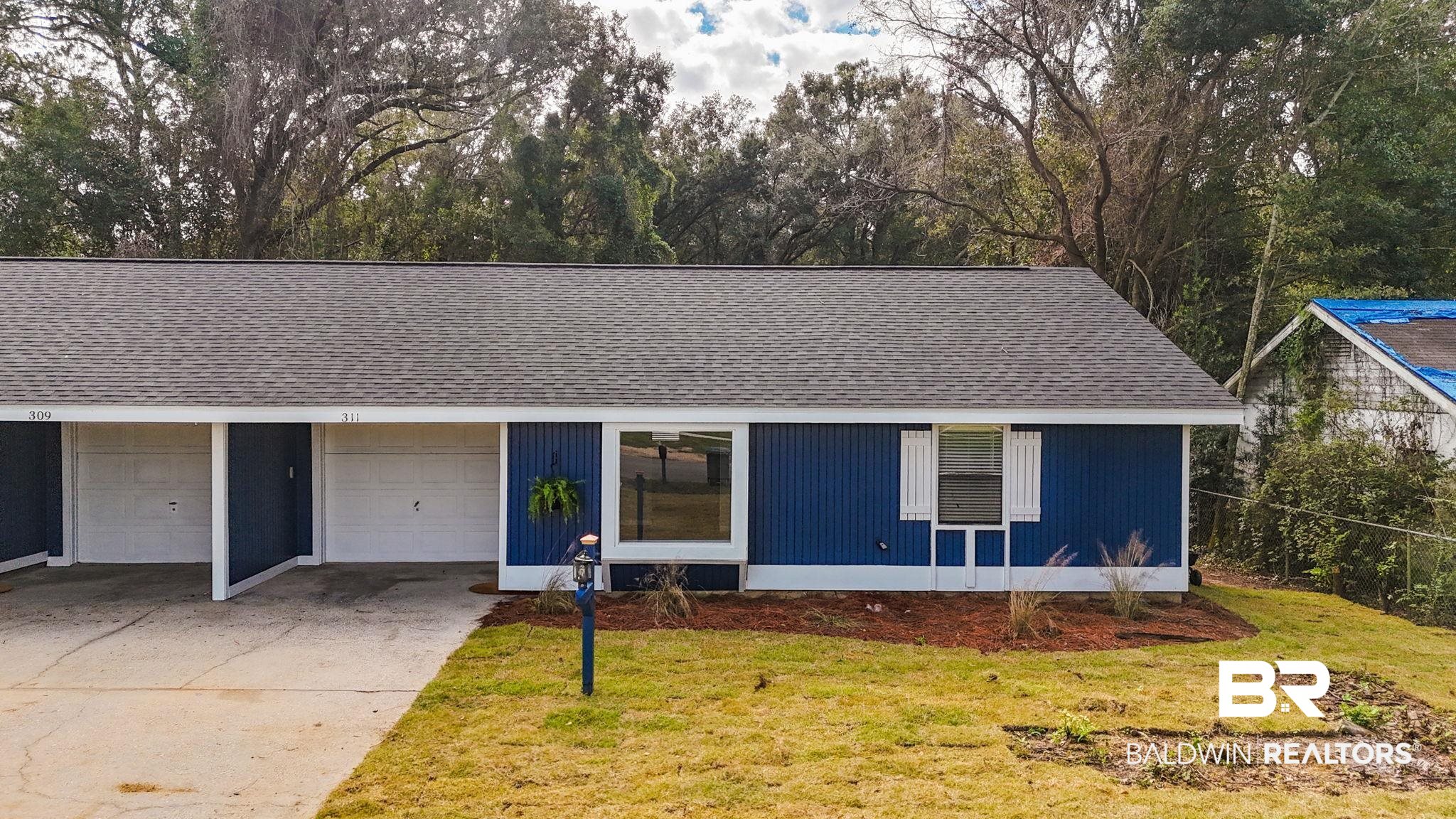 309 West Roosevelt Avenue Foley, AL 36535 - Photo 25 of 60 Single story home featuring a garage and a front lawn