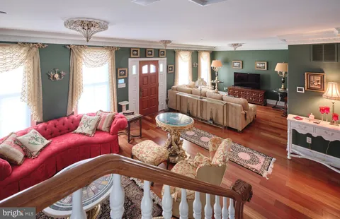 a bedroom with furniture and a flat screen tv