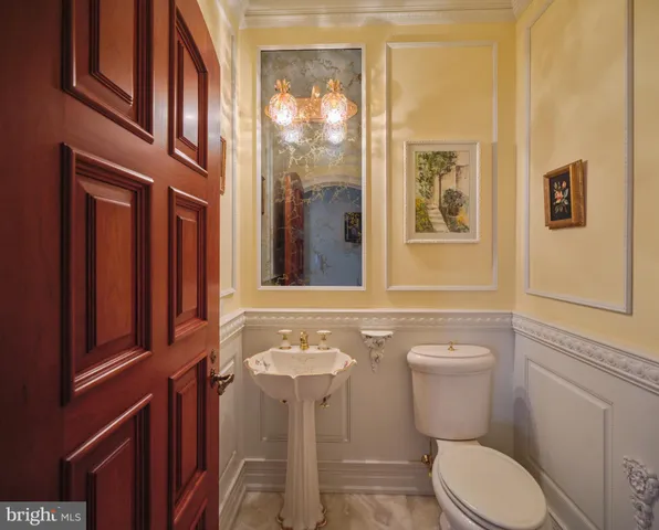 a bathroom with a toilet a sink and mirror