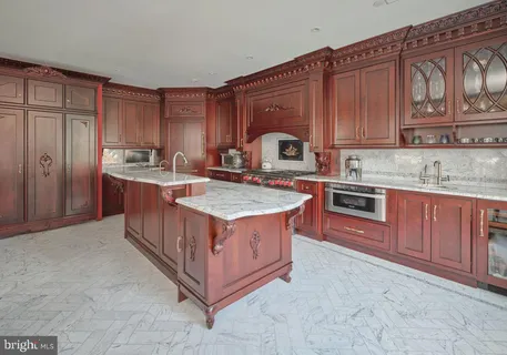 a kitchen with stainless steel appliances granite countertop a stove a sink a refrigerator and cabinets