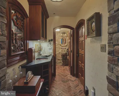 a view of living room filled with furniture and chandelier