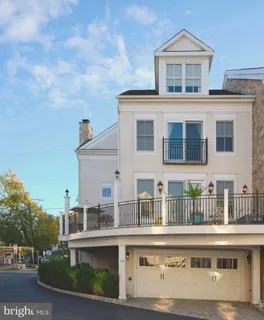 a view of a dining room and livingroom with furniture wooden floor and a rug