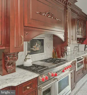 a kitchen with stainless steel appliances granite countertop a stove and a sink