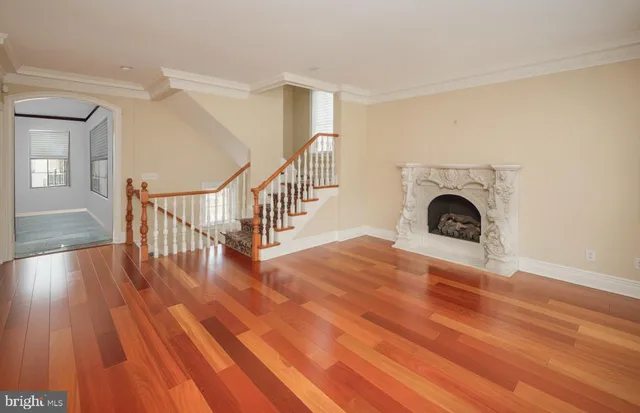 a view of empty room with wooden floor and fireplace