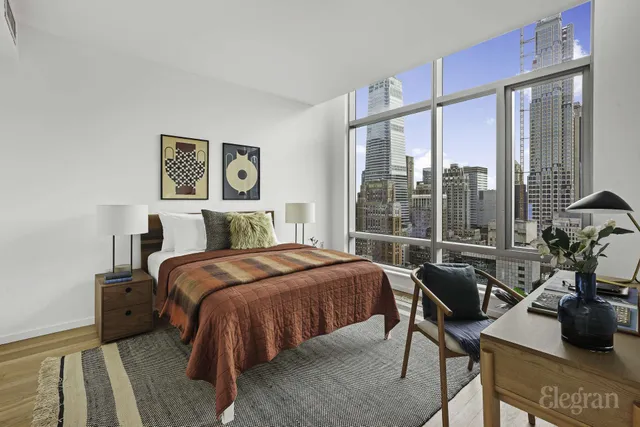 a view of a hallway with a livingroom and furniture