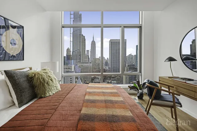 a bed sitting in a bedroom next to a window