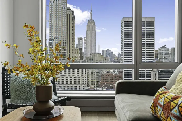 a front view of a house with wooden floor and furniture