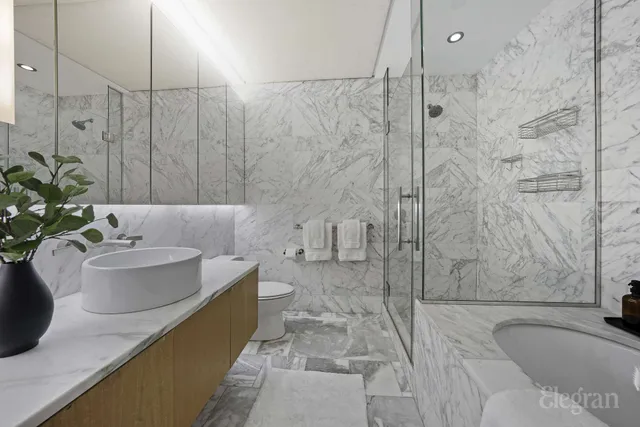 a bath tub sitting next to a white sink