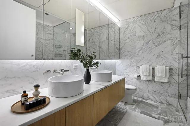 a bathroom with a granite countertop bathtub sink vanity and toilet