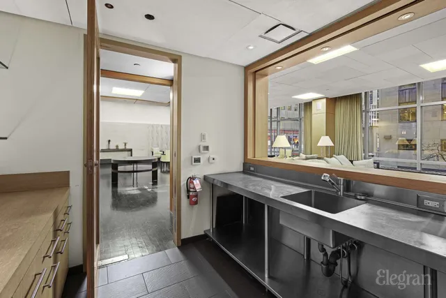 a room with lots of furniture and painting on the wall