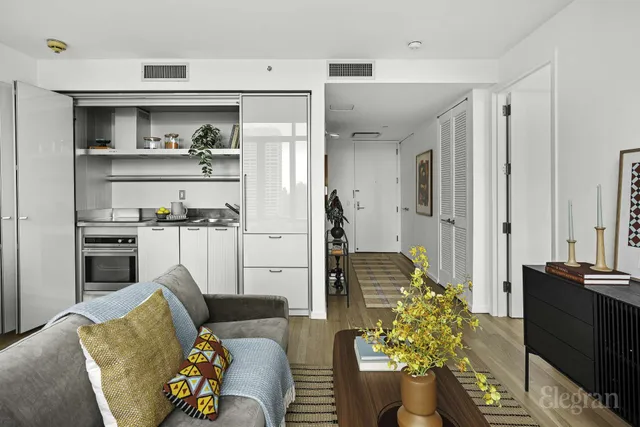 a kitchen with white cabinets and appliances