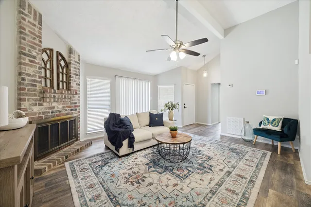 a living room with furniture and wooden floor